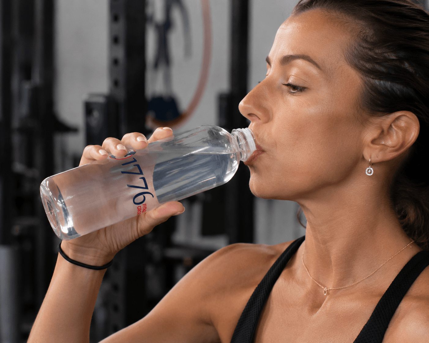 1776 Fitness Group bottle mid-workout in the gym