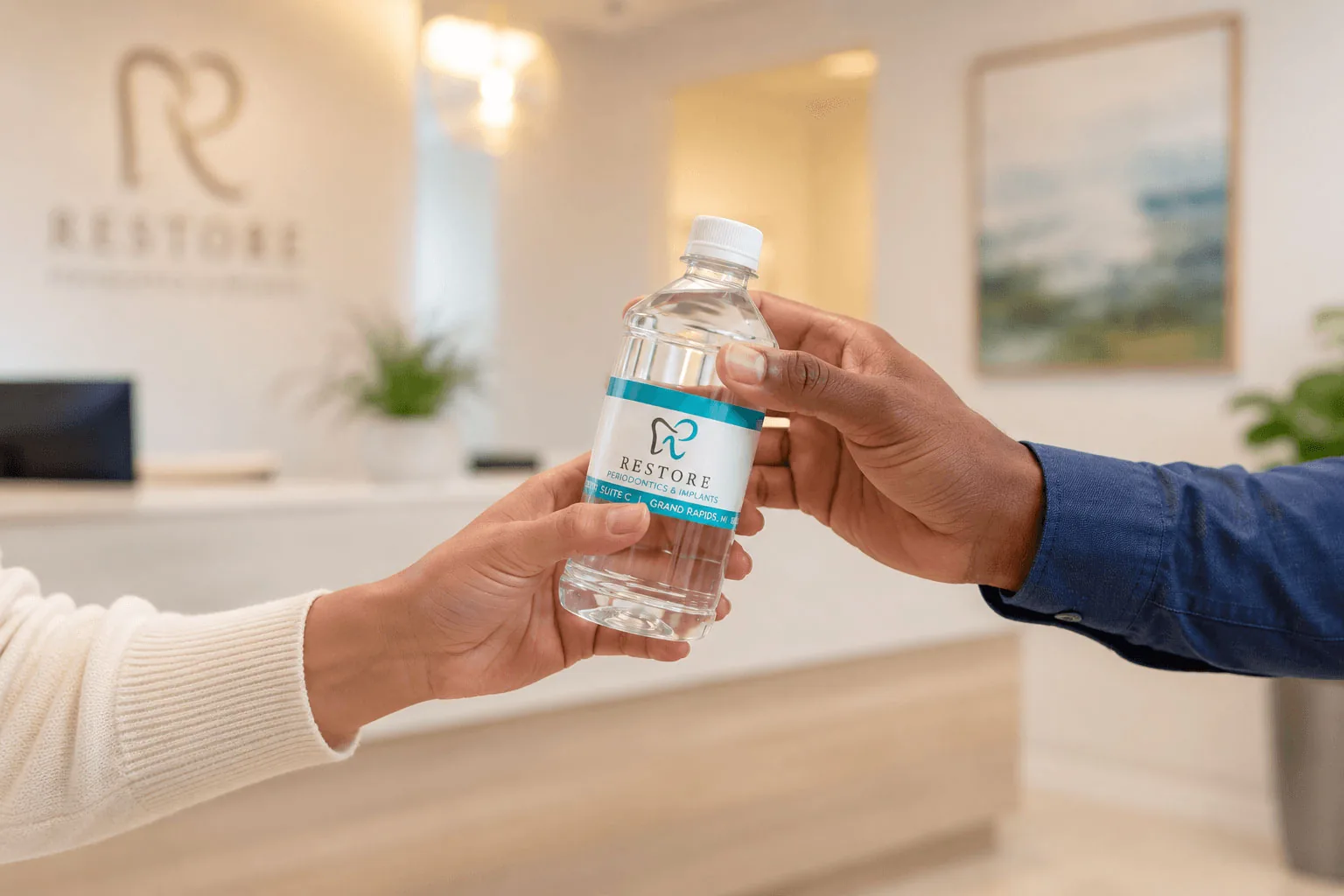 Restore Periodontics bottle handed from one person to another at the front desk